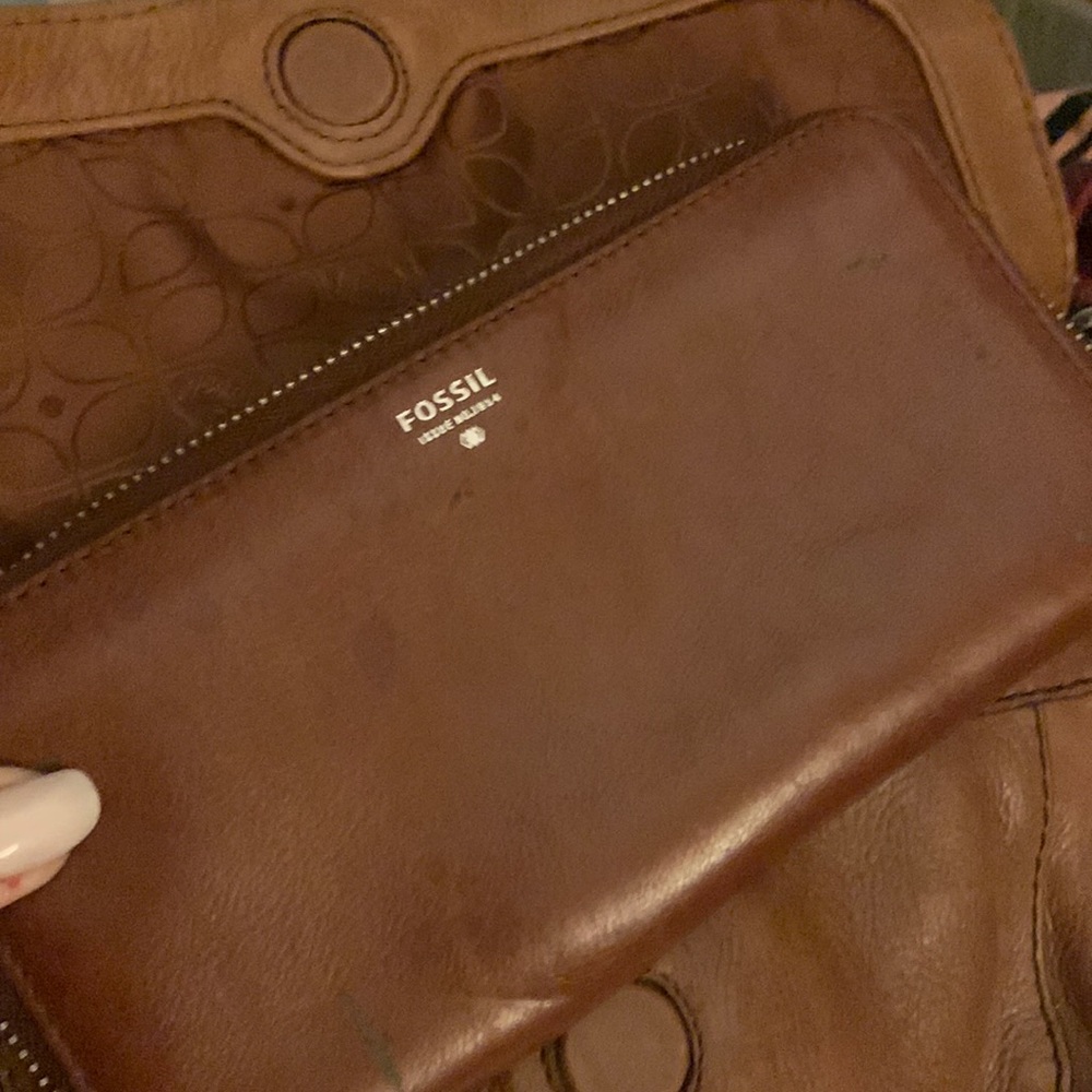 A brown leather fossil wallet in great condition .